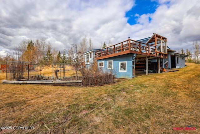16500 E Smith Rd, Palmer, AK 99645 - rear view of property featuring a yard, a wooden deck, and stucco siding