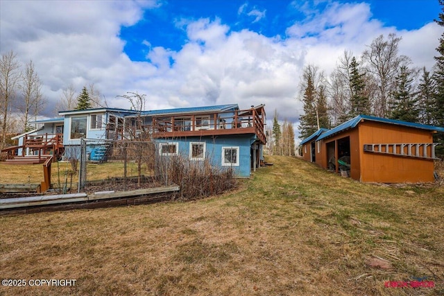 16500 E Smith Rd, Palmer, AK 99645 - back of house featuring a pole building, a wooden deck, an outdoor structure, and a yard