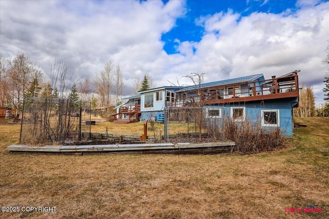 16500 E Smith Rd, Palmer, AK 99645 - rear view of house featuring a lawn and a wooden deck