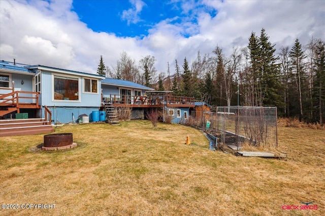 16500 E Smith Rd, Palmer, AK 99645 - view of yard featuring a wooden deck, a fire pit, and stairway