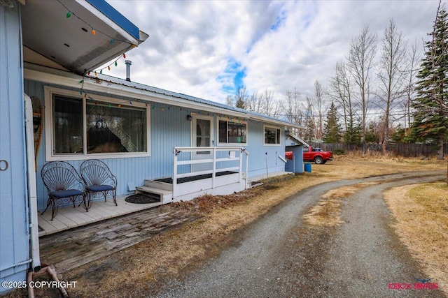 16500 E Smith Rd, Palmer, AK 99645 - exterior space with dirt driveway, fence, a wooden deck, and metal roof