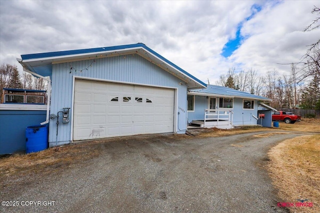 16500 E Smith Rd, Palmer, AK 99645 - single story home featuring an attached garage, metal roof, driveway, and covered porch