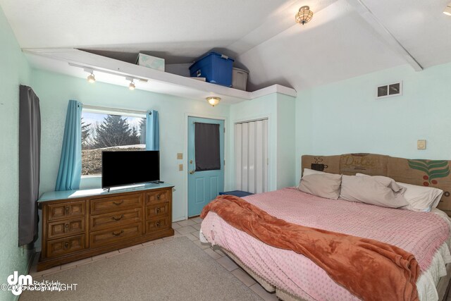 65265 Knob Hill Rd, Anchor Point, AK 99556 - bedroom featuring visible vents, a closet, light tile patterned floors, and lofted ceiling