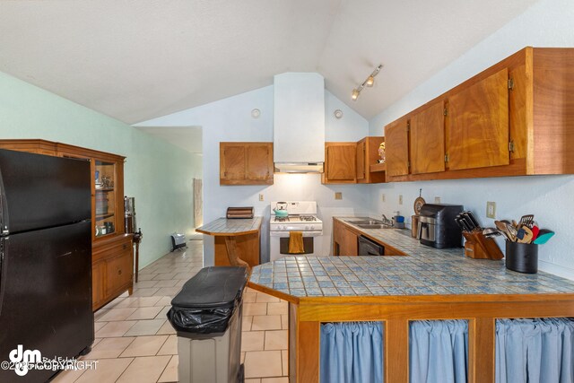 65265 Knob Hill Rd, Anchor Point, AK 99556 - kitchen with light tile patterned floors, brown cabinetry, a peninsula, black appliances, and a sink