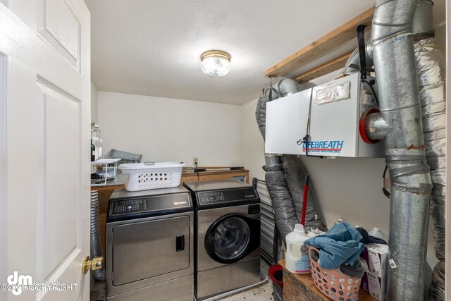 65265 Knob Hill Rd, Anchor Point, AK 99556 - laundry room with laundry area, washing machine and clothes dryer, and a textured ceiling