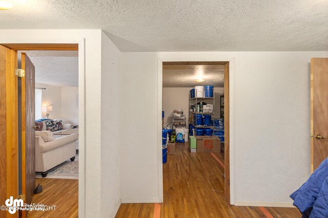 65265 Knob Hill Rd, Anchor Point, AK 99556 - corridor featuring wood finished floors and a textured ceiling