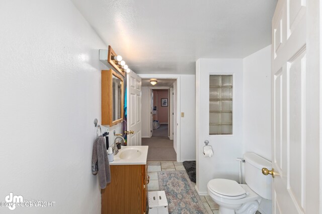 65265 Knob Hill Rd, Anchor Point, AK 99556 - bathroom with toilet, vanity, and tile patterned flooring