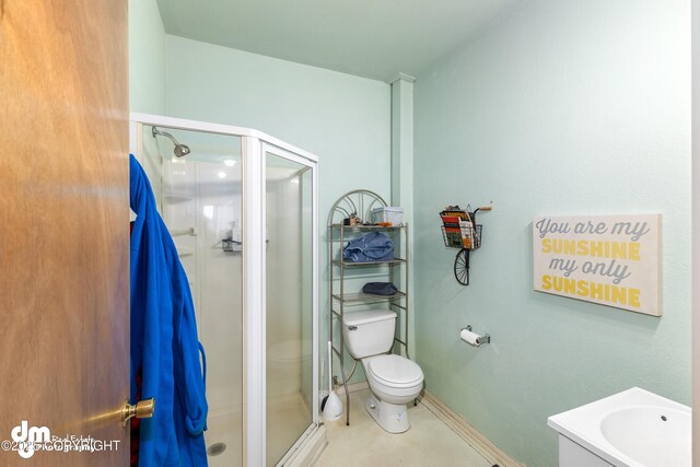 65265 Knob Hill Rd, Anchor Point, AK 99556 - bathroom with a shower stall, vanity, baseboards, and toilet