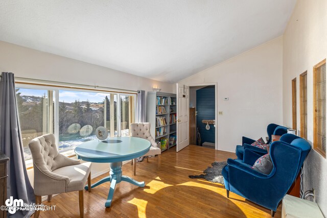 65265 Knob Hill Rd, Anchor Point, AK 99556 - dining area with baseboards, wood finished floors, and vaulted ceiling