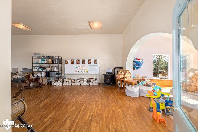 65265 Knob Hill Rd, Anchor Point, AK 99556 - interior space with arched walkways, wood finished floors, and a wood stove