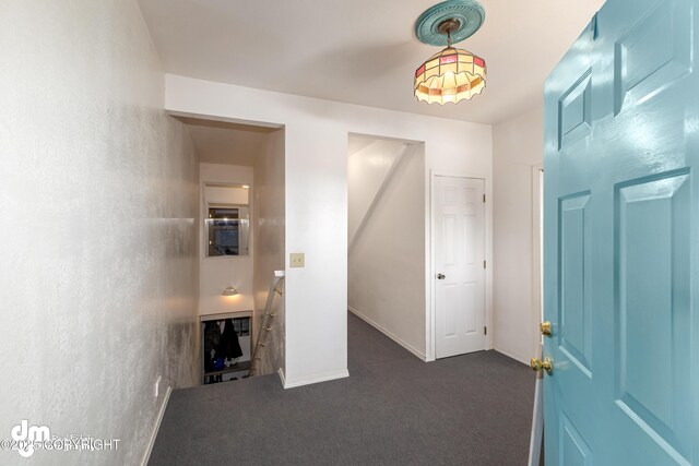 65265 Knob Hill Rd, Anchor Point, AK 99556 - hall featuring baseboards, dark colored carpet, and an upstairs landing