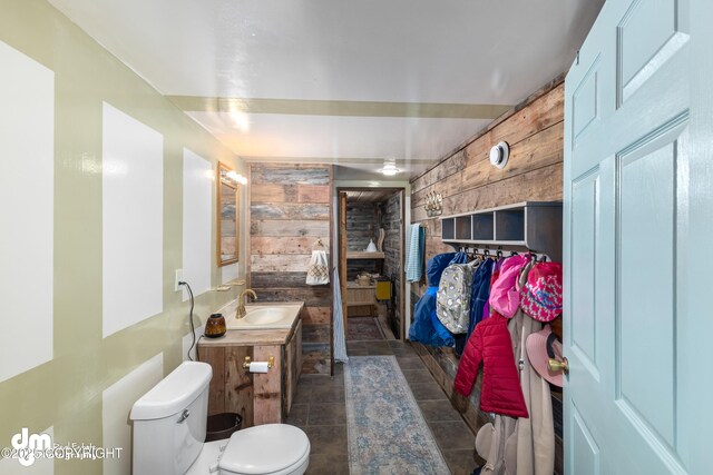 65265 Knob Hill Rd, Anchor Point, AK 99556 - bathroom featuring wooden walls, vanity, and toilet