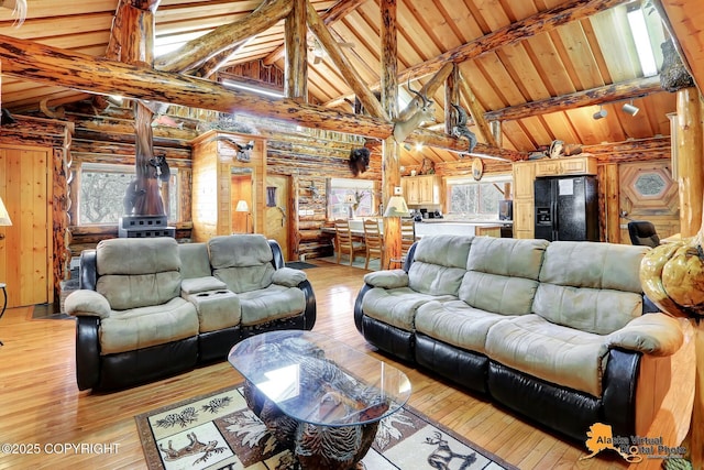 living area featuring wood ceiling, high vaulted ceiling, and beamed ceiling