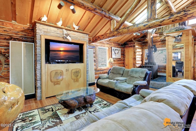 living area featuring log walls, wooden ceiling, vaulted ceiling with beams, and wood finished floors