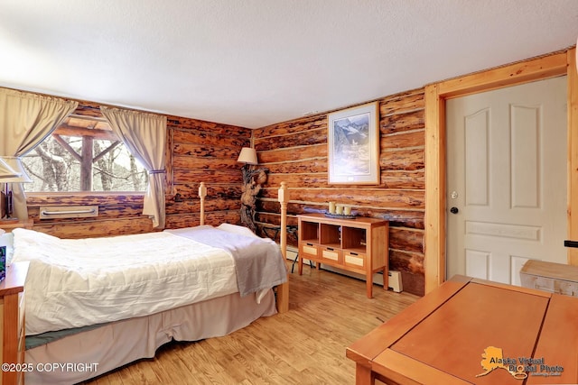 bedroom with light wood-style floors and rustic walls
