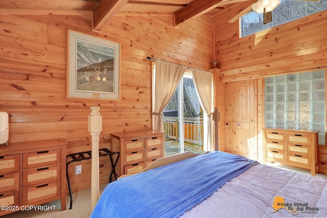 bedroom featuring wood walls, access to outside, and lofted ceiling with beams
