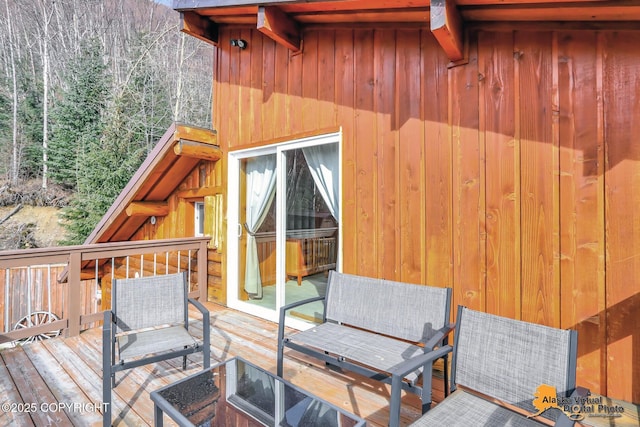wooden terrace with a wooded view