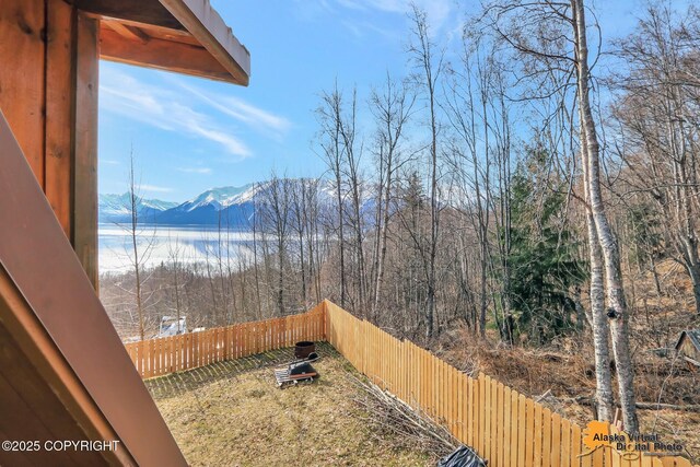 view of yard featuring a mountain view and a fenced backyard