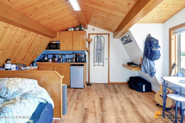 interior space with lofted ceiling with beams, dishwashing machine, black microwave, wooden ceiling, and light wood finished floors