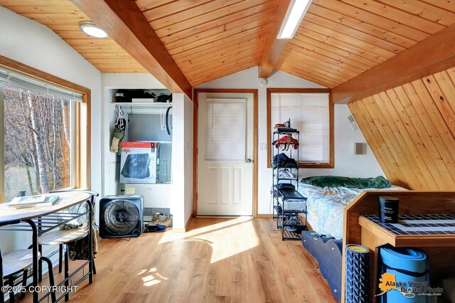 interior space with wood ceiling, laundry area, and wood finished floors