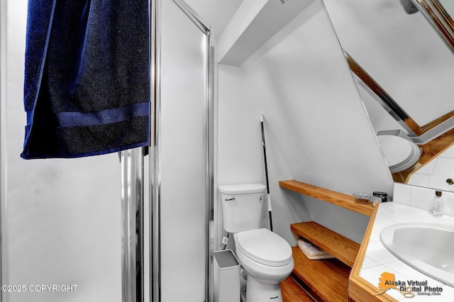 bathroom featuring vanity, a stall shower, backsplash, and toilet