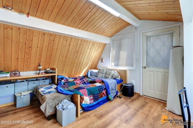 bedroom featuring vaulted ceiling with beams, wood finished floors, and wood ceiling