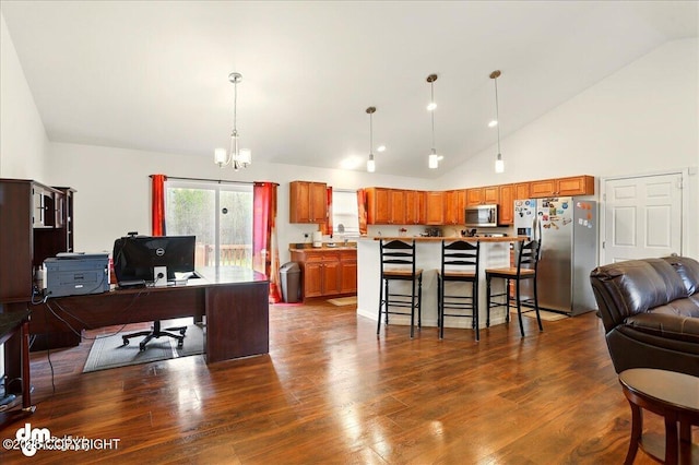 3762-3768 S Lansing Rd, Wasilla, AK 99654 - kitchen with appliances with stainless steel finishes, open floor plan, a breakfast bar area, brown cabinetry, and high vaulted ceiling