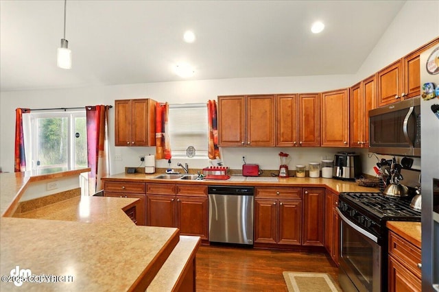 3762-3768 S Lansing Rd, Wasilla, AK 99654 - kitchen featuring appliances with stainless steel finishes, a sink, light countertops, dark wood finished floors, and decorative light fixtures