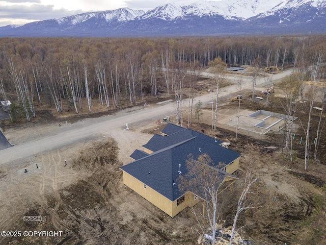 drone / aerial view featuring a view of trees and a mountain view