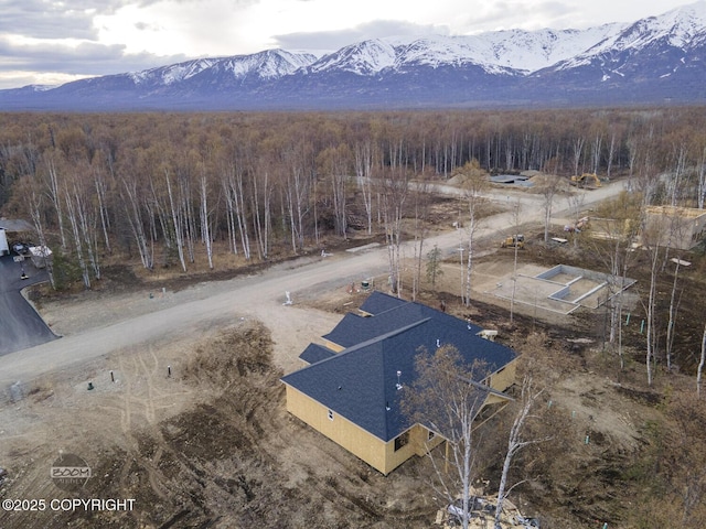 drone / aerial view with a mountain view and a wooded view