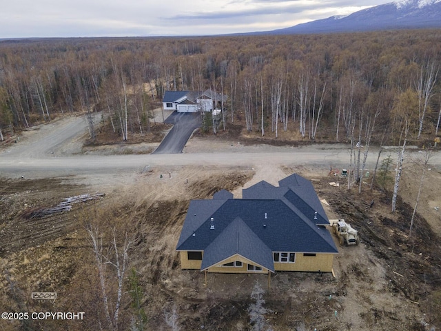 aerial view featuring a wooded view