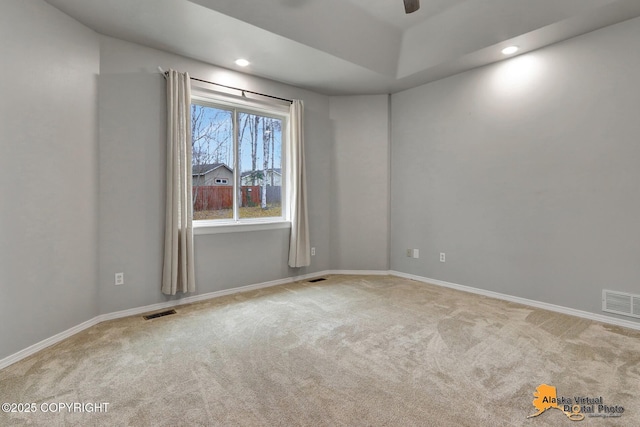 carpeted spare room featuring recessed lighting, visible vents, and baseboards