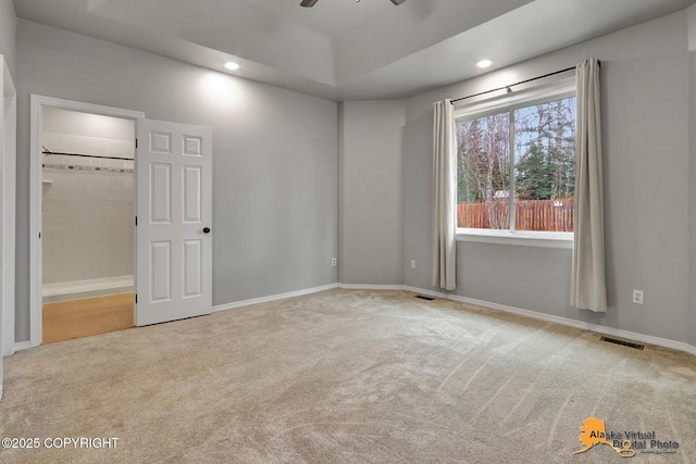 spare room featuring visible vents, baseboards, recessed lighting, and carpet