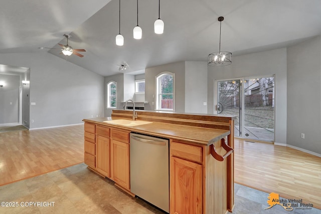 kitchen featuring ceiling fan, vaulted ceiling, dishwasher, a sink, and open floor plan