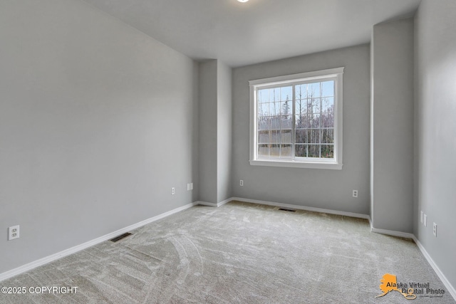 empty room featuring visible vents, baseboards, and carpet floors