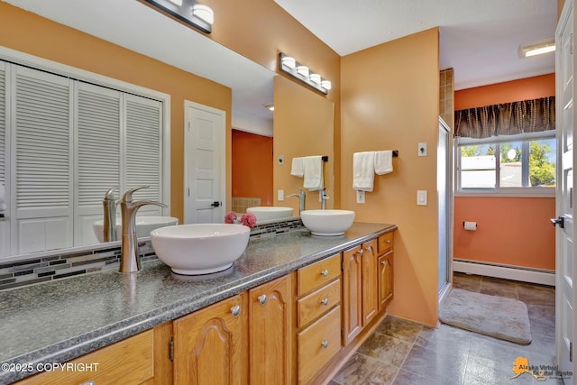 2500 Maylen Cir, Anchorage, AK 99516 - full bathroom with a baseboard radiator, a closet, double vanity, a shower stall, and baseboards