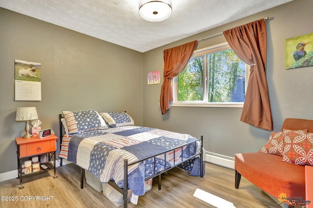 2500 Maylen Cir, Anchorage, AK 99516 - bedroom with a baseboard radiator, wood finished floors, a textured ceiling, and baseboards