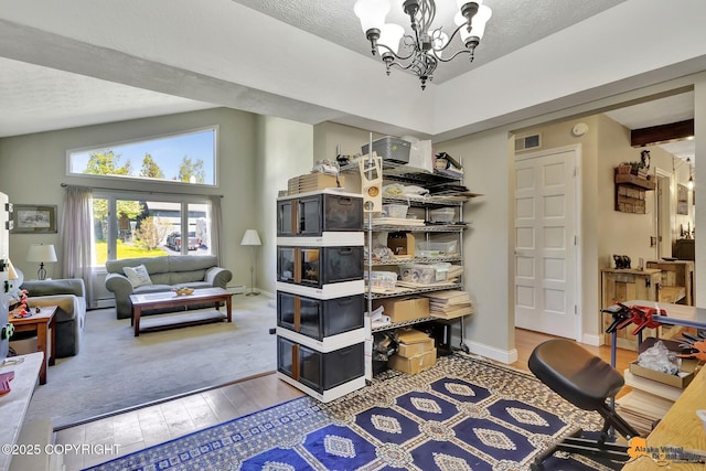 2500 Maylen Cir, Anchorage, AK 99516 - living area featuring a chandelier, wood finished floors, a textured ceiling, and baseboards