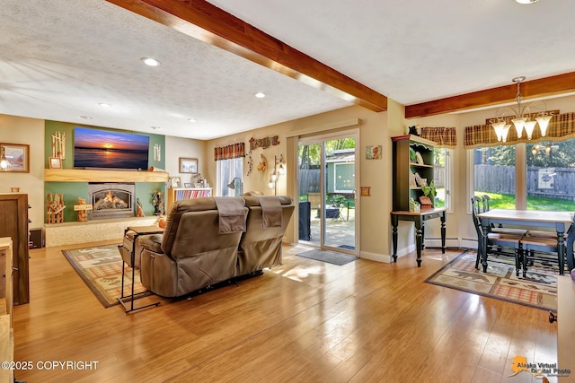 2500 Maylen Cir, Anchorage, AK 99516 - living area with a chandelier, hardwood / wood-style floors, a glass covered fireplace, recessed lighting, and beamed ceiling