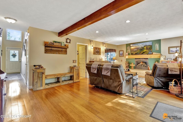 2500 Maylen Cir, Anchorage, AK 99516 - living room with plenty of natural light, light wood-style floors, recessed lighting, beam ceiling, and a warm lit fireplace