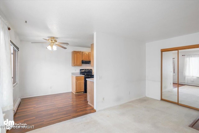 315 Krane Dr # 19, Anchorage, AK 99504 - unfurnished living room with a baseboard heating unit, wood finished floors, and ceiling fan