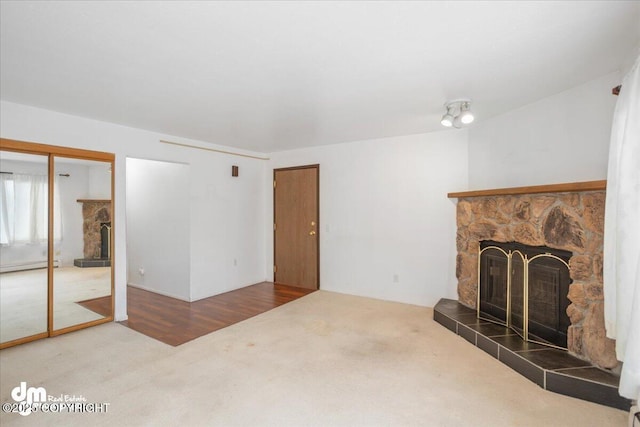 315 Krane Dr # 19, Anchorage, AK 99504 - unfurnished living room featuring a stone fireplace and carpet flooring