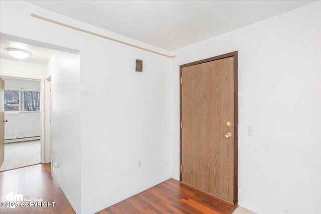 315 Krane Dr # 19, Anchorage, AK 99504 - empty room featuring a baseboard heating unit and wood finished floors