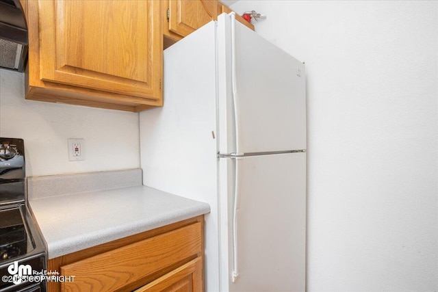 315 Krane Dr # 19, Anchorage, AK 99504 - kitchen with range, light countertops, and freestanding refrigerator