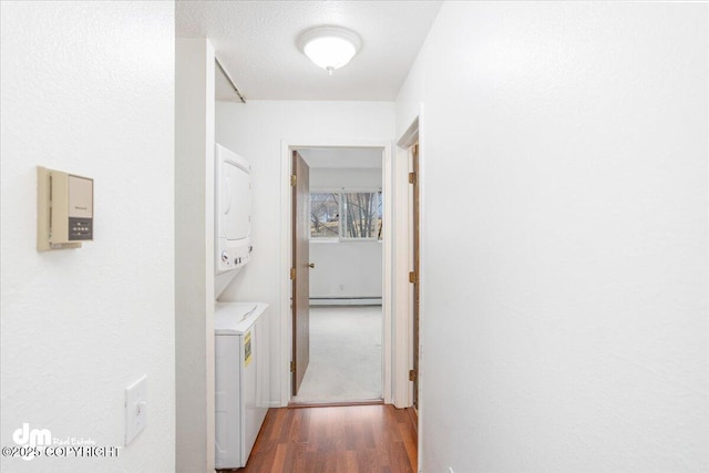 315 Krane Dr # 19, Anchorage, AK 99504 - corridor with stacked washer and clothes dryer, wood finished floors, and a baseboard radiator