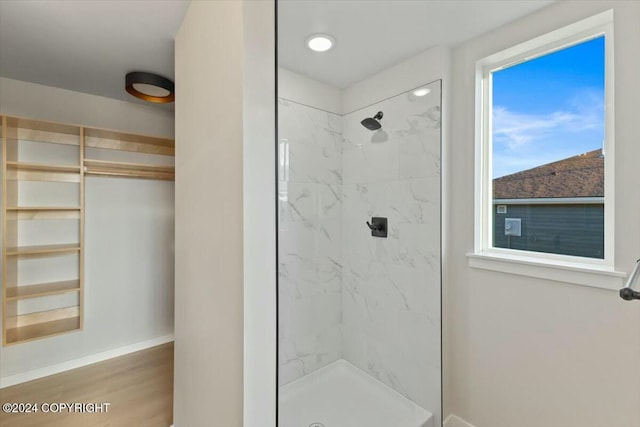 1029 Shelley Ave, Homer, AK 99603 - bathroom featuring a marble finish shower, healthy amount of natural light, and wood finished floors