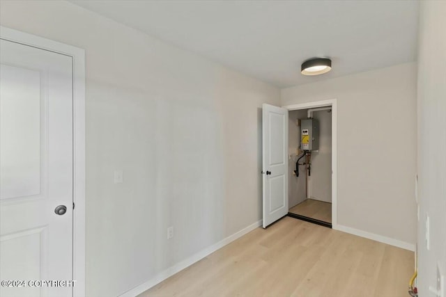 1029 Shelley Ave, Homer, AK 99603 - empty room featuring light wood-type flooring and water heater