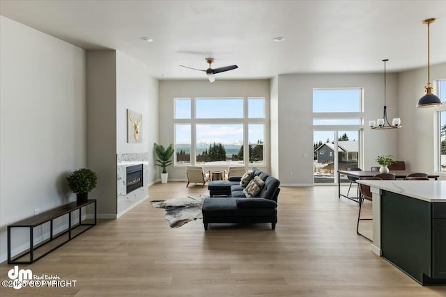 1029 Shelley Ave, Homer, AK 99603 - living room featuring a high end fireplace, a chandelier, light wood-style flooring, and recessed lighting