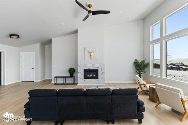 1029 Shelley Ave, Homer, AK 99603 - living room featuring ceiling fan, wood finished floors, and a high end fireplace