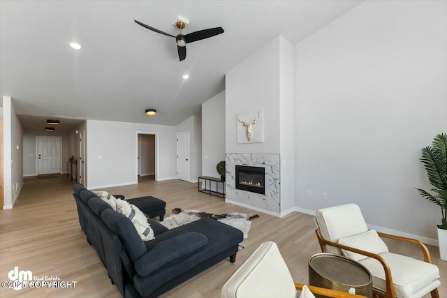 1029 Shelley Ave, Homer, AK 99603 - living area with ceiling fan, a premium fireplace, light wood finished floors, and vaulted ceiling